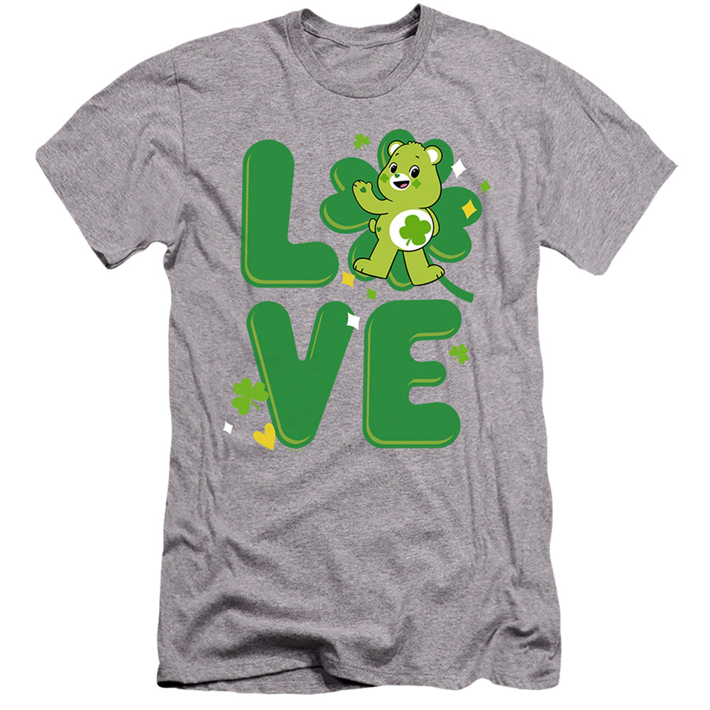 AN OFFCIALLY LICENSED CARE BEARS: UNLOCK THE MAGIC GOOD LUCK BEAR LOVE ST. PATRICK'S DAY MEN'S PREMIUM SLIM FIT T-SHIRT ATHLETIC HEATHER
