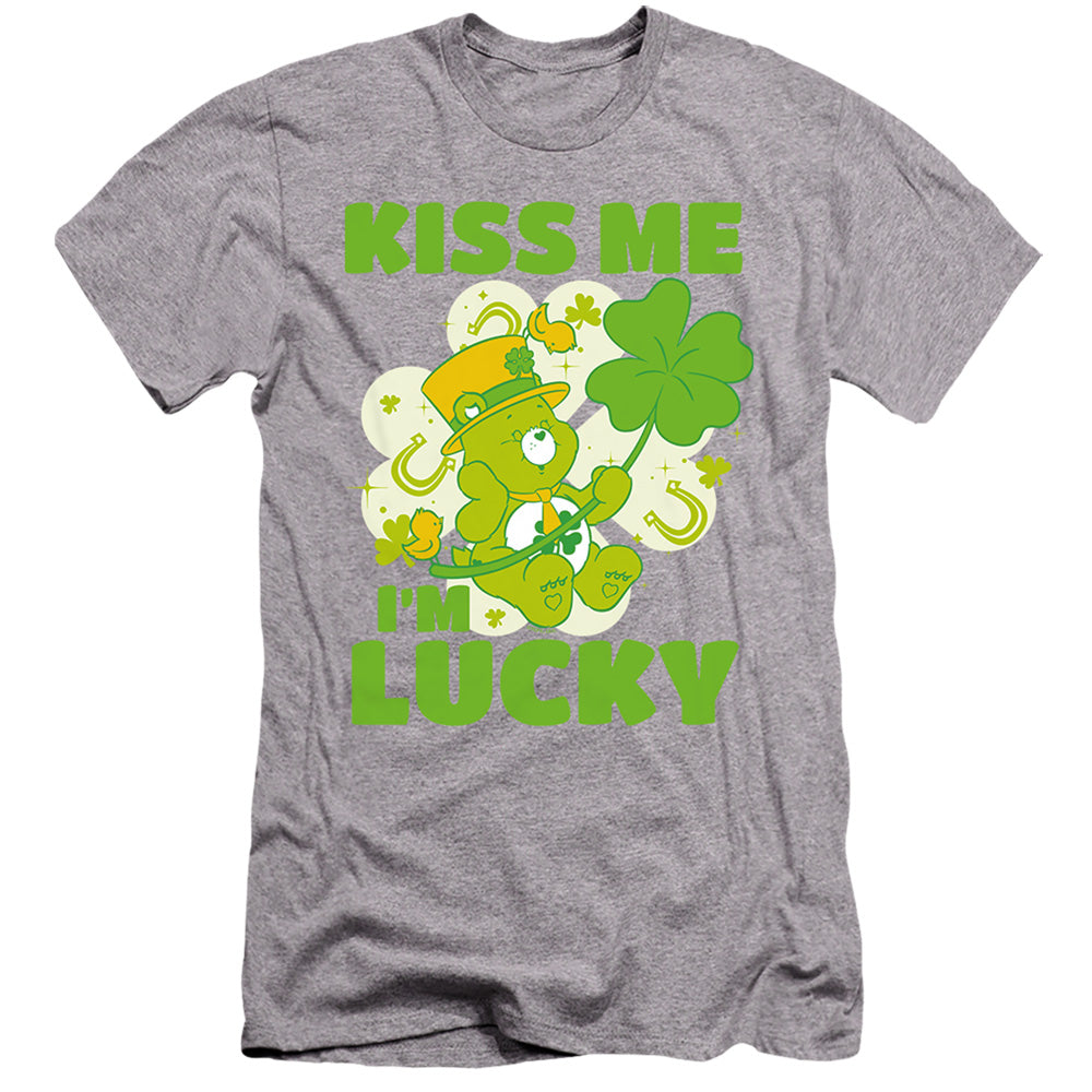 AN OFFCIALLY LICENSED CARE BEARS KISS ME I'M LUCKY ST. PATRICK'S DAY GOOD LUCK BEAR MEN'S PREMIUM SLIM FIT T-SHIRT ATHLETIC HEATHER