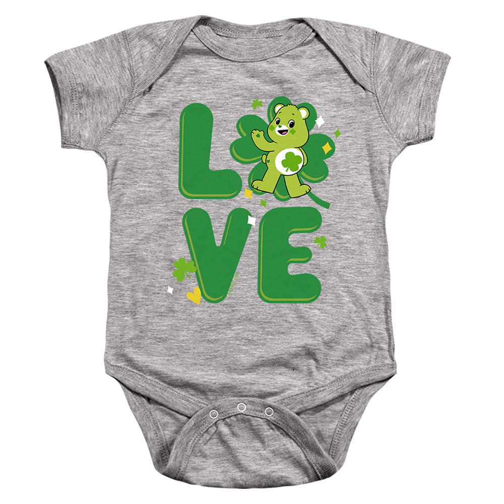 AN OFFCIALLY LICENSED CARE BEARS: UNLOCK THE MAGIC GOOD LUCK BEAR LOVE ST. PATRICK'S DAY BABY BODYSUIT ATHLETIC HEATHER