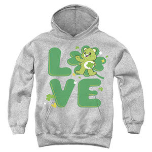 AN OFFCIALLY LICENSED CARE BEARS: UNLOCK THE MAGIC GOOD LUCK BEAR LOVE ST. PATRICK'S DAY YOUTH HOODIE ATHLETIC HEATHER