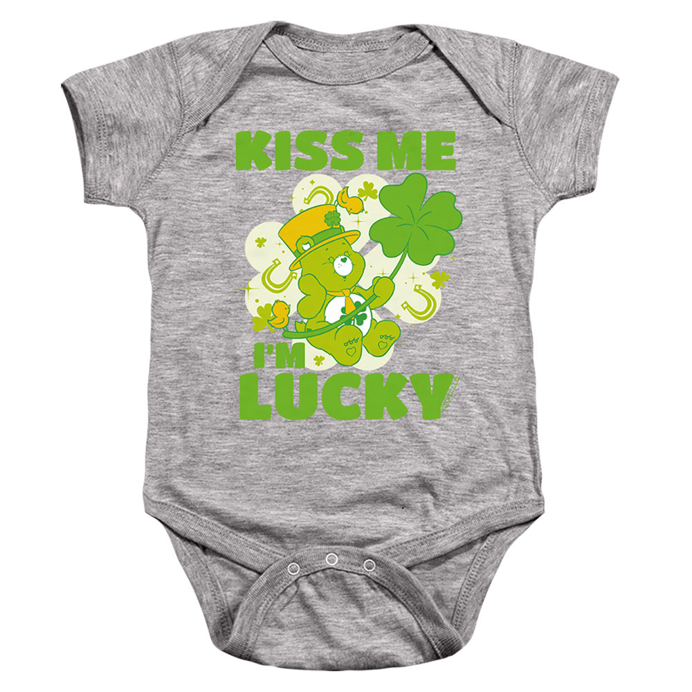 AN OFFCIALLY LICENSED CARE BEARS KISS ME I'M LUCKY ST. PATRICK'S DAY GOOD LUCK BEAR BABY BODYSUIT ATHLETIC HEATHER